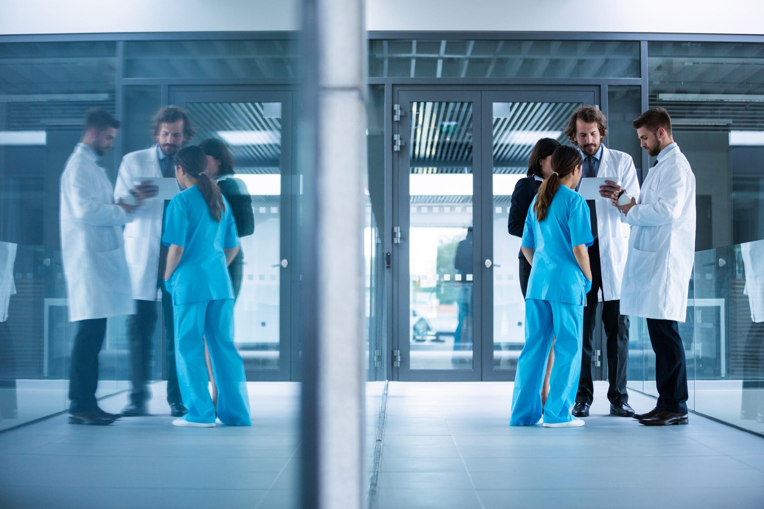 Businesswoman interacting with doctors in hospital